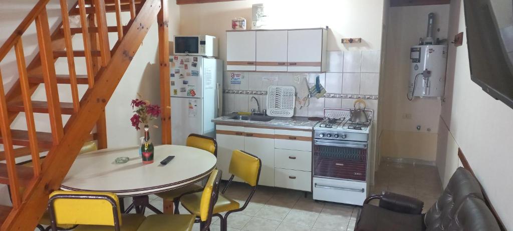 a kitchen with a table and a table and chairs at Duplex Cuty Nakey in Puerto Madryn