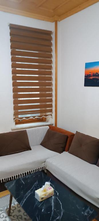 two beds in a room with a table and a window at In the Heart of Istanbul in Istanbul