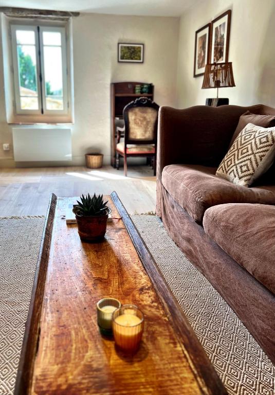 a living room with a couch and a wooden coffee table at Maison Marie in Lagarde