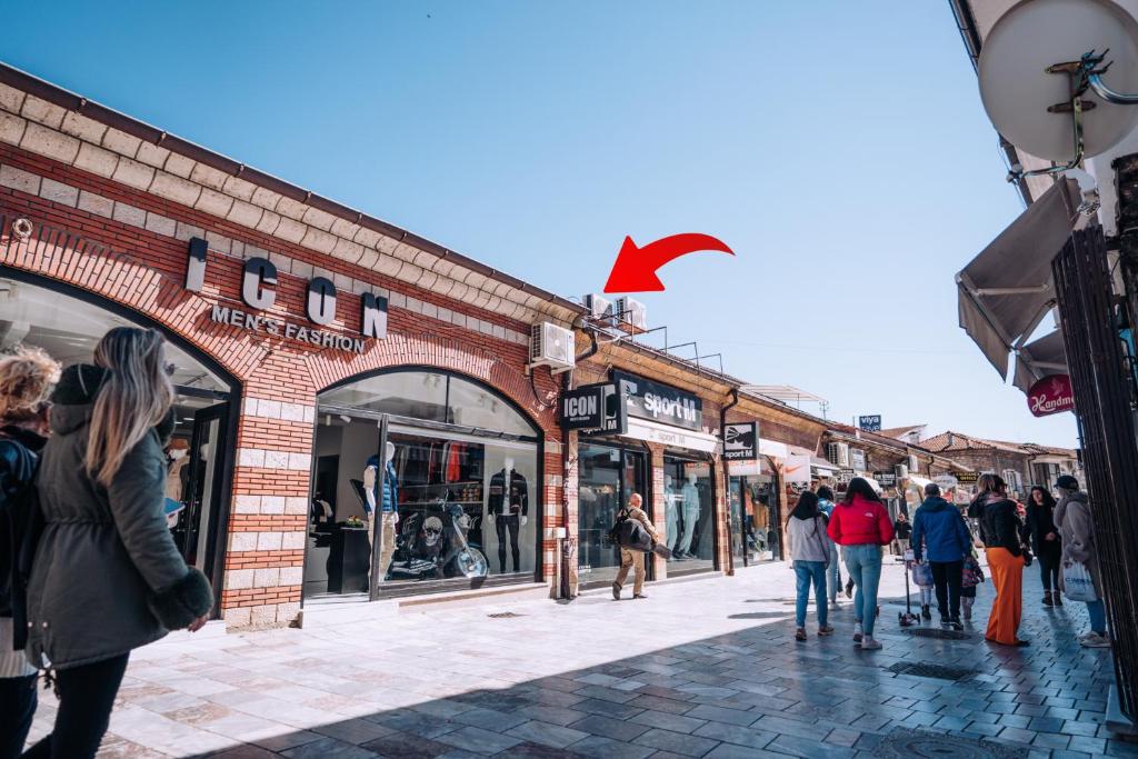a group of people walking in front of a brick building at Darni Central Apartments - Bazaar Location With Free Parking in Ohrid