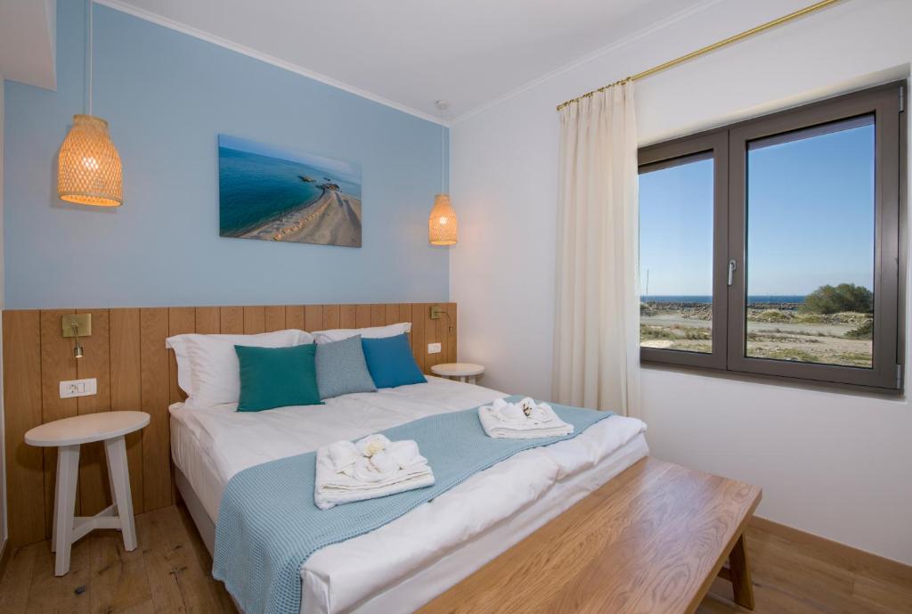 a bedroom with a bed with towels on it at Christos Place-Paleochora in Palaiochora