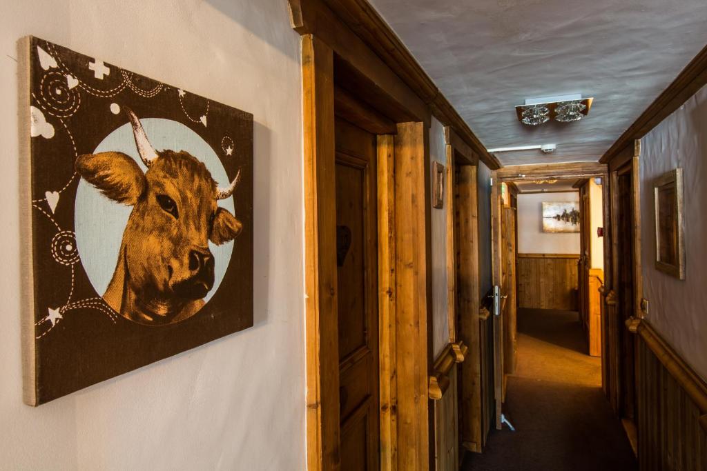 a picture of a cow hanging on a wall at Les Monts Charvin in Courchevel