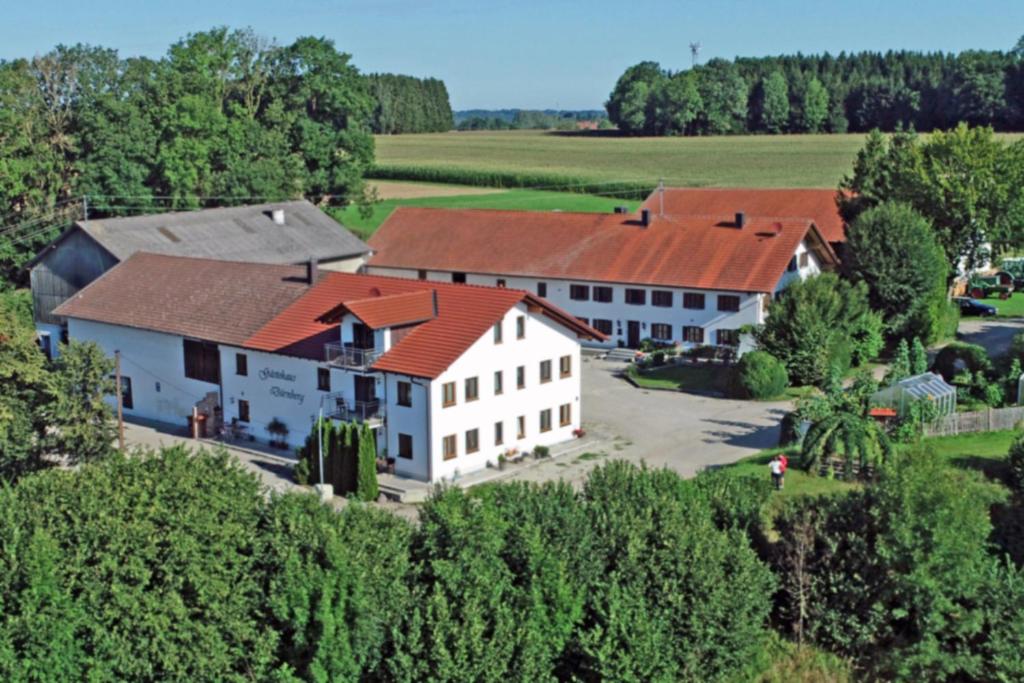 an aerial view of a large white building with red roofs at Gästehaus Dürnberg in Pastetten