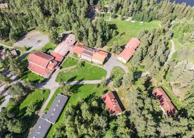 an aerial view of a farm with buildings and trees at Voionmaa Voionmajoitus in Ylöjärvi