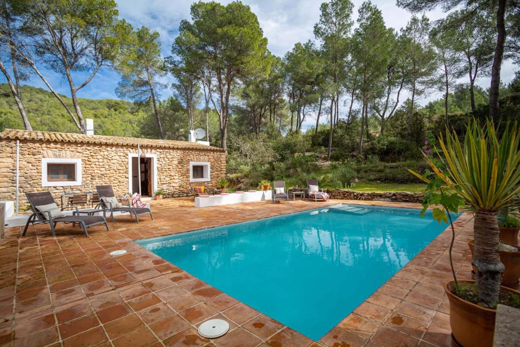 a villa with a swimming pool and a patio at Can Font in Santa Eularia des Riu