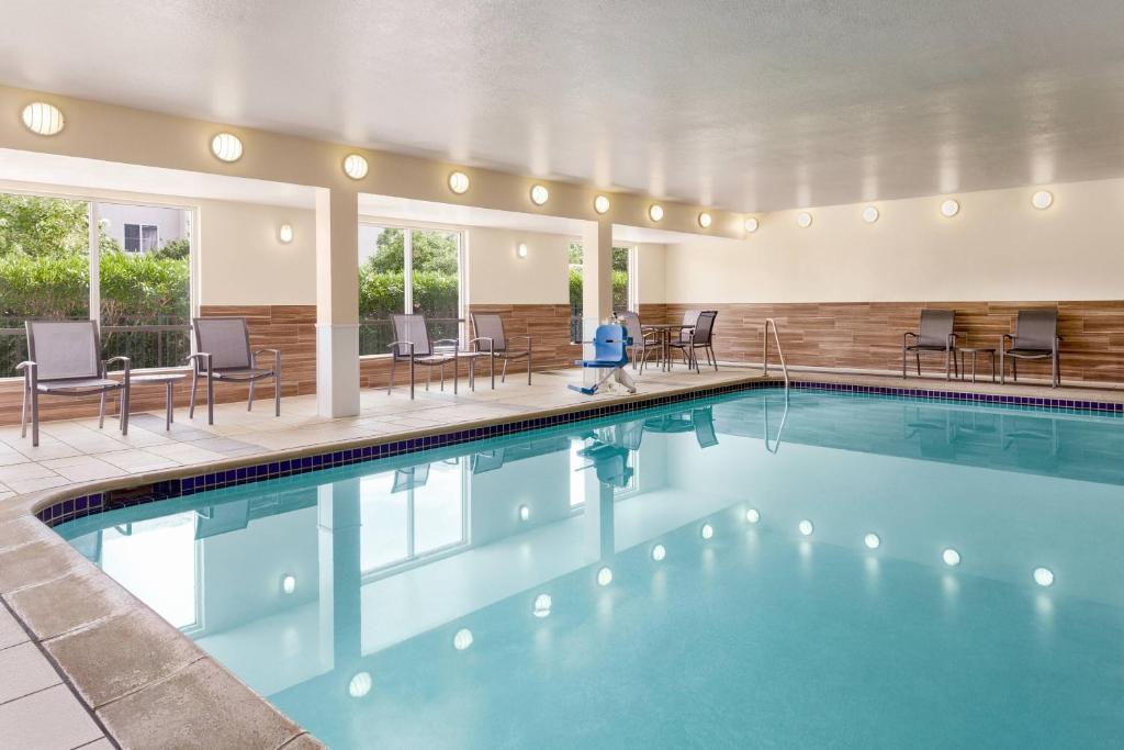 a pool at a hotel with chairs and tables at Fairfield Inn Vacaville in Vacaville