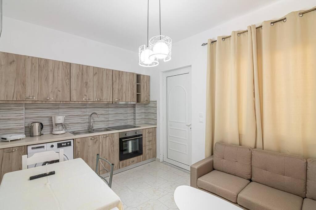 a kitchen with a couch and a table in a room at Fotis House 2 in Afantou