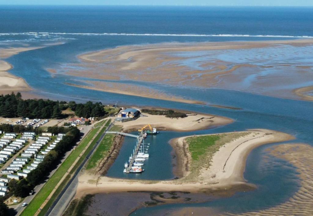 an aerial view of a marina with boats in the water at AnchorageWells Lodge, Seaview Apartment in Wells next the Sea