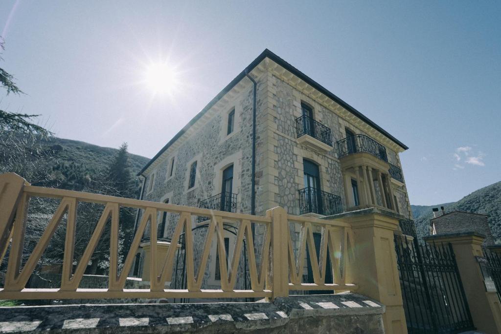 a house with a wooden fence in front of it at Casa Montero in Viniegra de Abajo