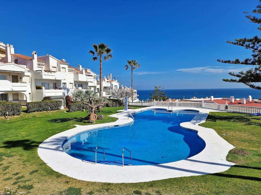 an image of a swimming pool at a resort at Hermoso Piso en La Cala de Mijas con vistas al mar in La Cala de Mijas