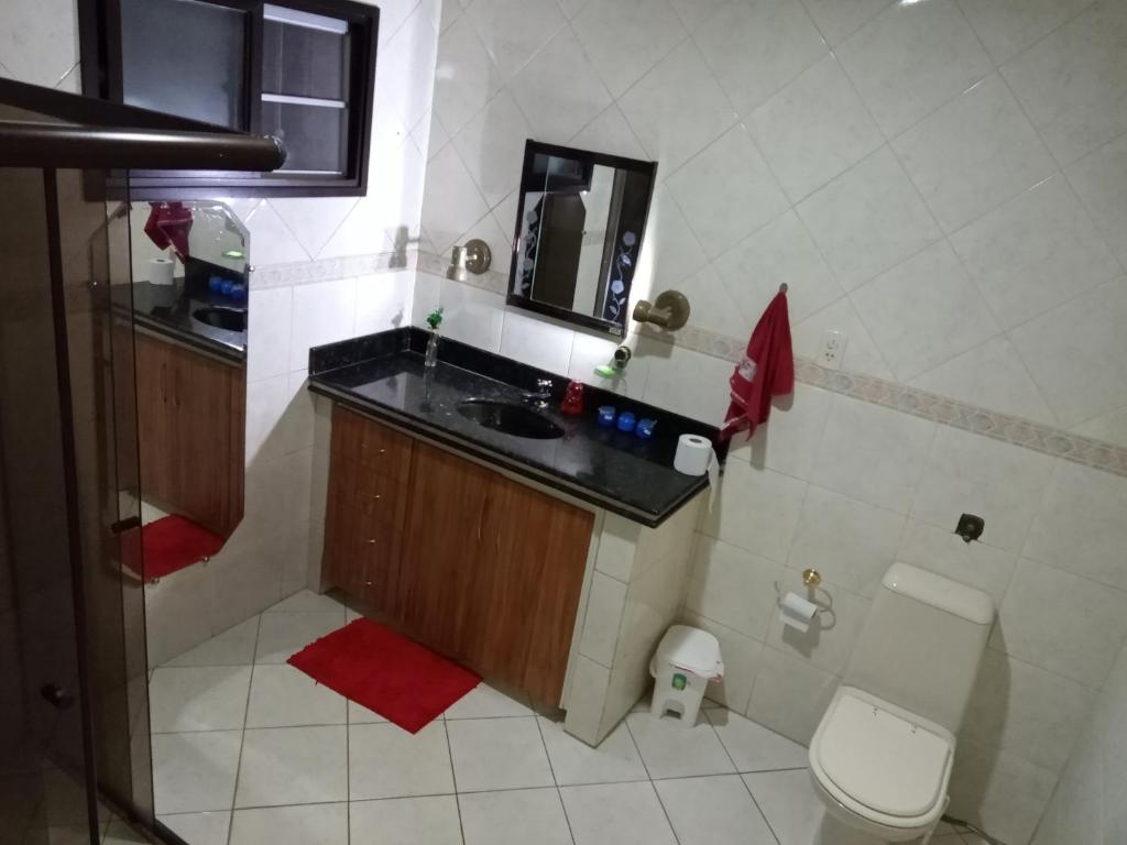 a small bathroom with a sink and a toilet at Hostel Da Penha in Vila Velha