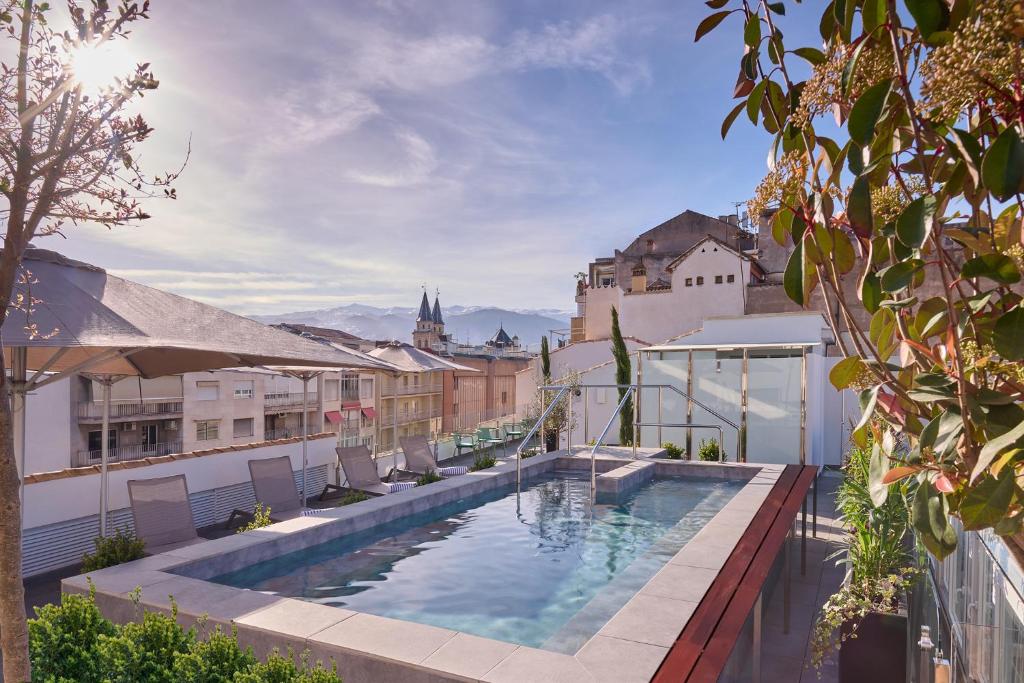 a swimming pool on the roof of a building at Boutique Hotel Luna Granada Centro in Granada