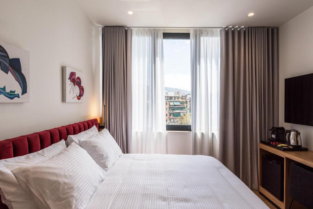 Postel nebo postele na pokoji v ubytování Urban Frame Acropolis