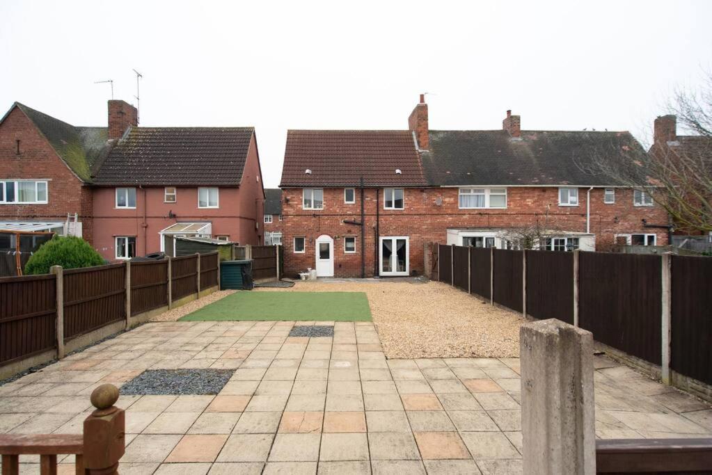 a house with a fence and a courtyard with houses at Sherwood Pines - Big Garden! in Clipstone