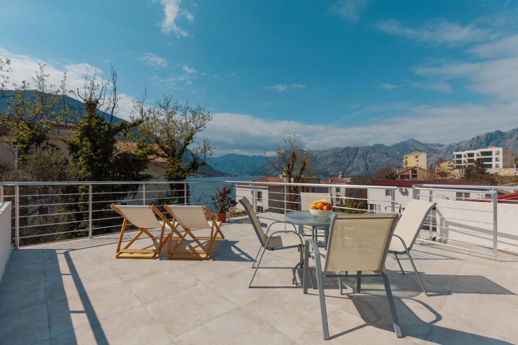 a patio with chairs and a table on a balcony at Apartment Aleksic in Kotor