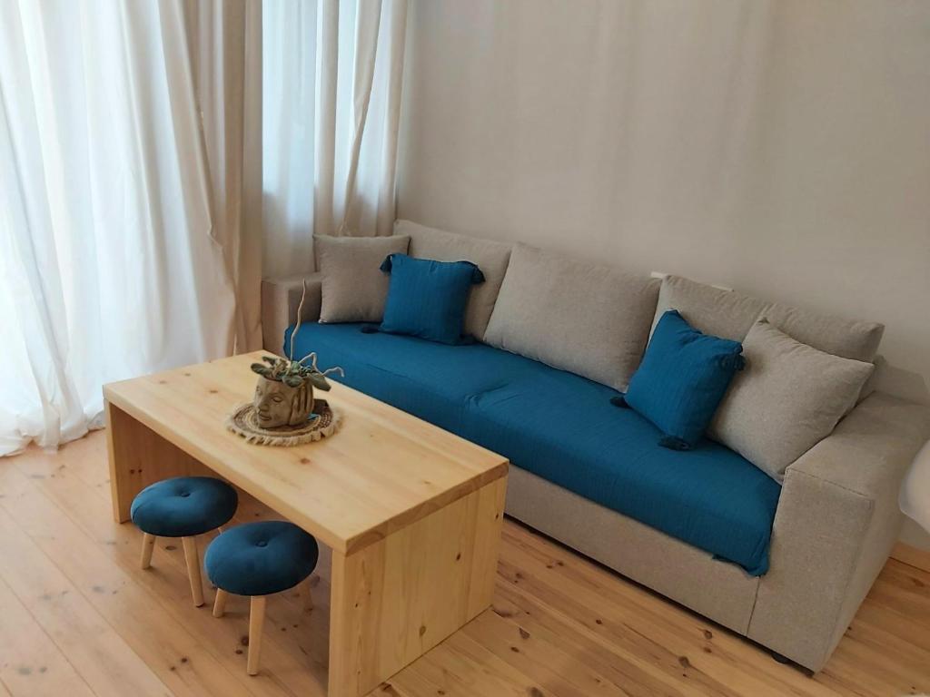 a living room with a blue couch and a table at SITIA CITY CENTER luxury apartment in Sitia