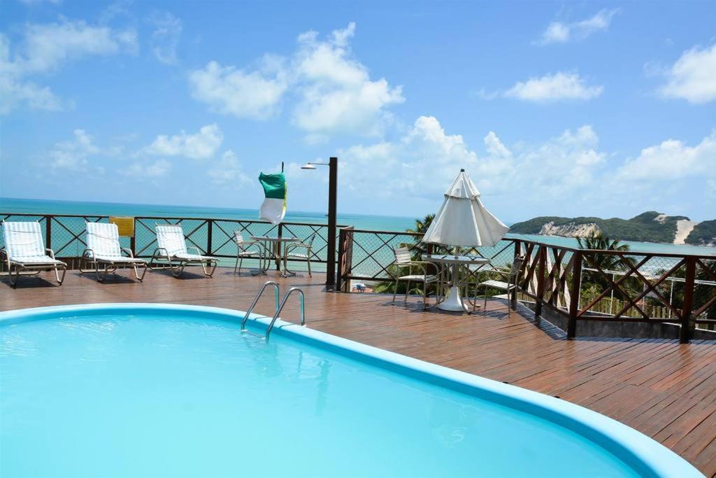 a swimming pool with a view of the ocean at Marsallis Residence Flat-EFM601 in Natal