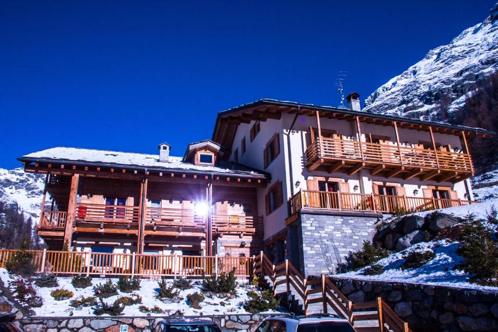 a large building with a mountain range at Ellex Hotel in Gressoney-la-Trinité