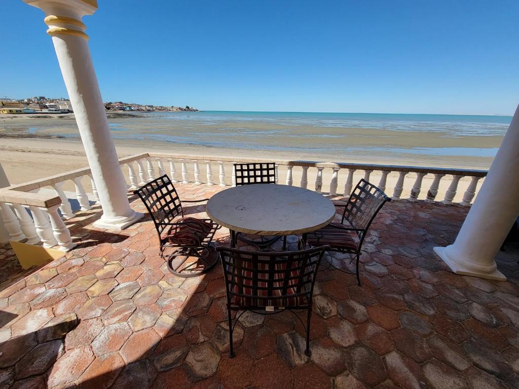 a table and chairs on a patio near the beach at Casa Medusa at Cholla Bay Rocky Point by Castaways in Puerto Peñasco