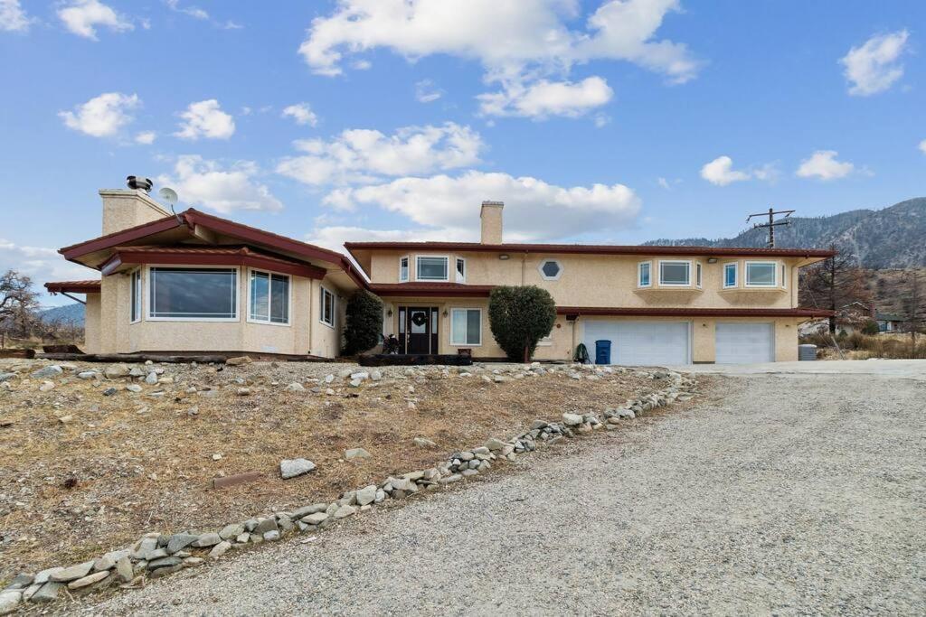 a house with a gravel driveway in front of it at The Big Sky in Pearblossom