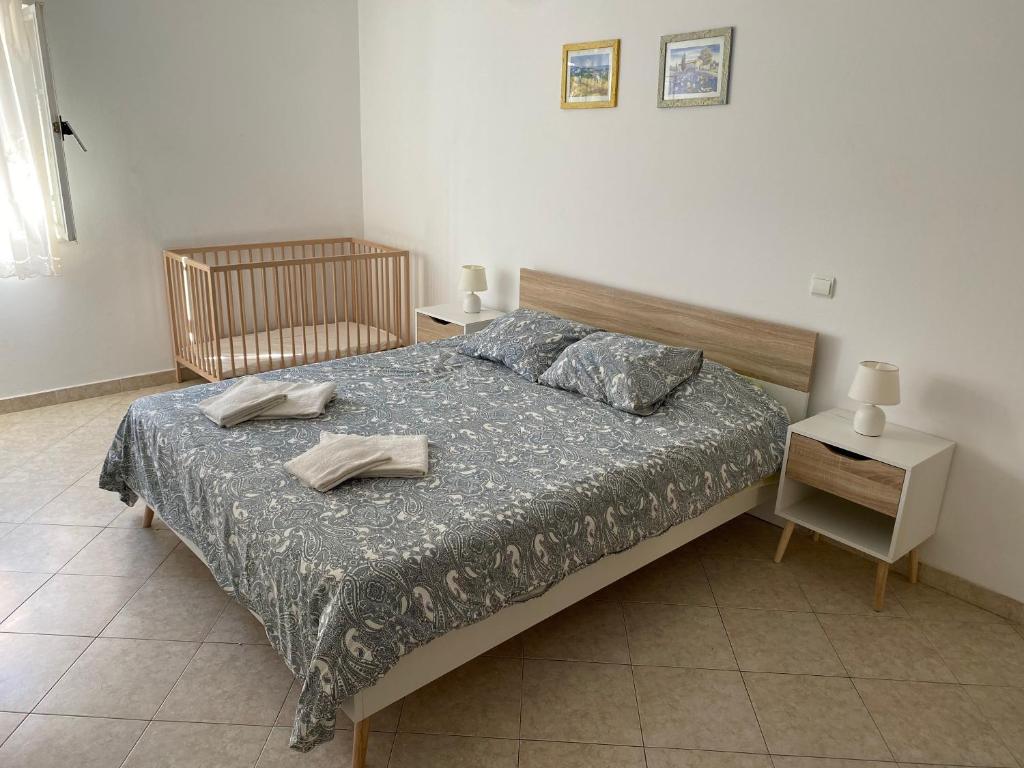 a bedroom with a bed with two towels on it at Alvor Apartments - Center and Beach in Alvor
