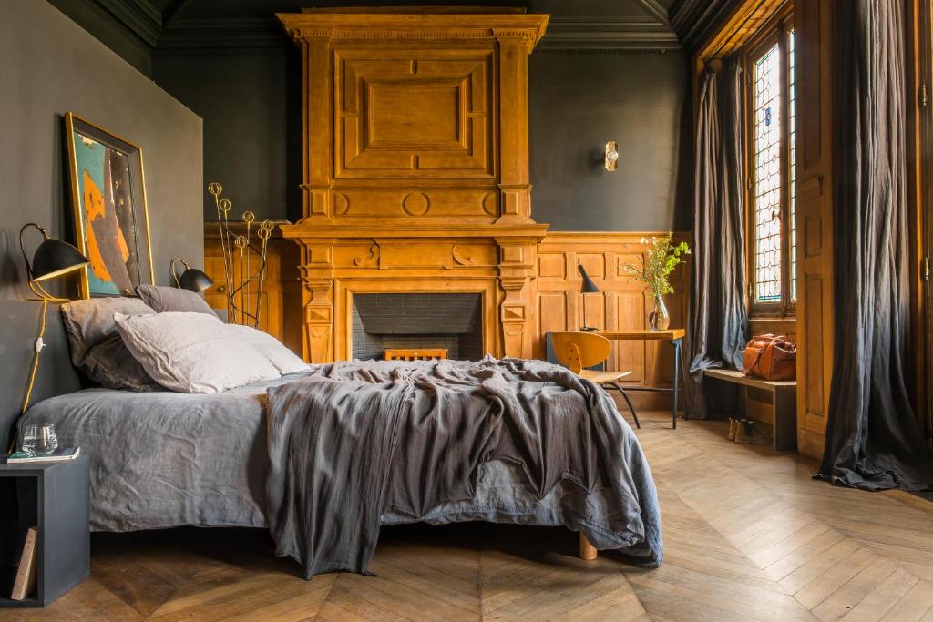 a bedroom with a bed and a fireplace at LE SECRET in Saint-Martin-de-Ré