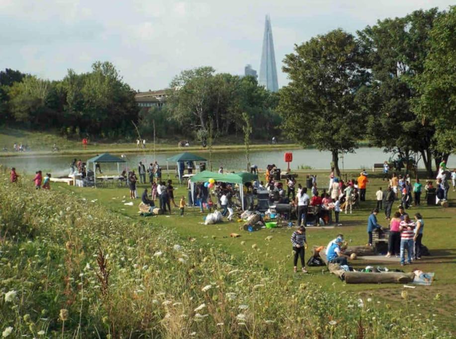 a crowd of people in a park near a body of water at 1 bed apartment in Zone 2, minutes from Oval tube. in London