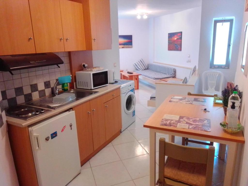 a kitchen with a stove and a microwave at GT Apartment in Rhodes Town