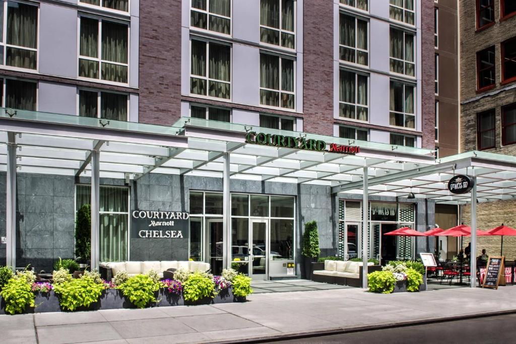 a restaurant with tables and chairs in front of a building at Courtyard by Marriott New York Manhattan/Chelsea in New York