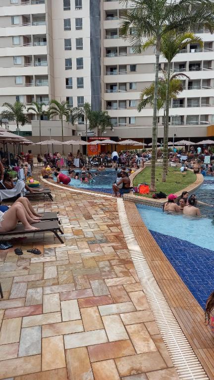 ein Swimmingpool mit Menschen, die auf Liegen in einem Resort liegen in der Unterkunft Solar das Águas Park Resort in Olímpia