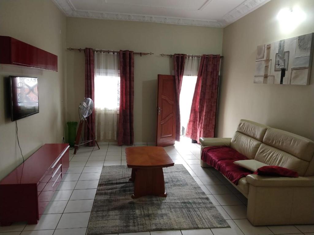 a living room with a couch and a table at ND SMART RESIDENCE in Limbe