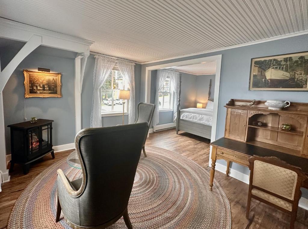 a living room with a chair and a desk and a bed at Orcas Hotel in Orcas