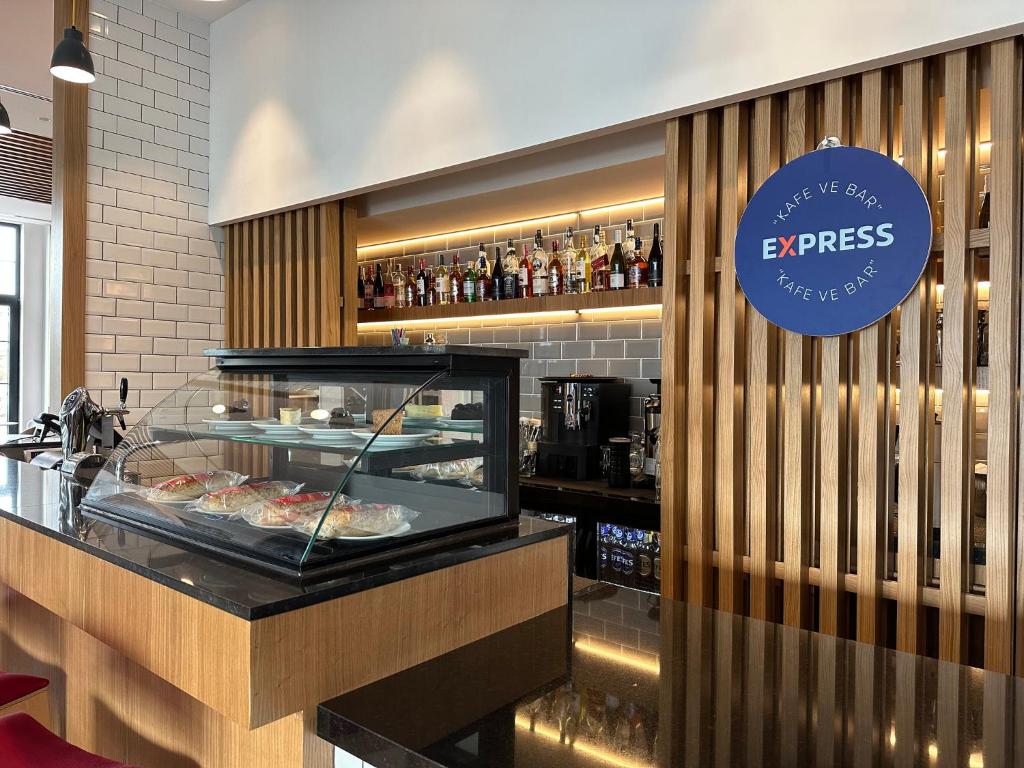 a restaurant with a counter with food on display at Holiday Inn Express - Ankara - Airport by IHG in Ankara
