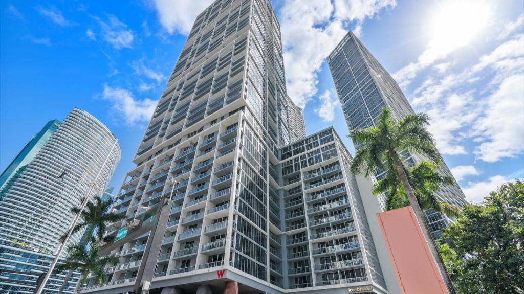 two tall skyscrapers in a city with palm trees at Icon Brickell 1 bed Miami 32nd in Miami