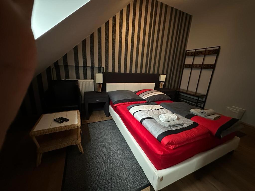 a bedroom with a bed with a red blanket at Adam's Hostel - Self Check-In & Room Just For You Alone in Düsseldorf