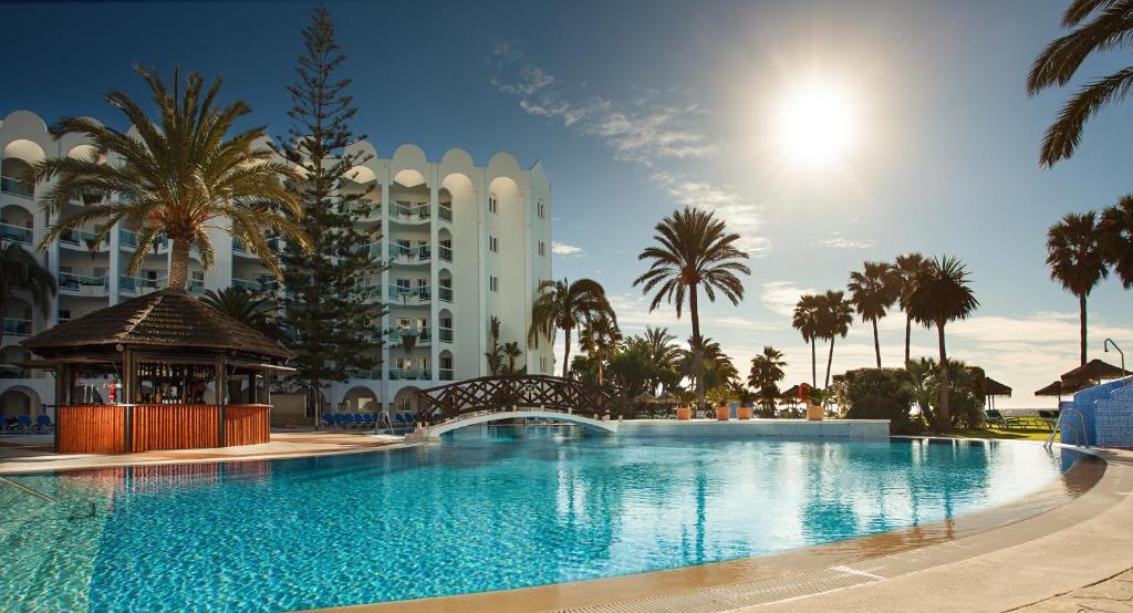 a large swimming pool in front of a large building at Marinas de Nerja Beach & Spa in Nerja