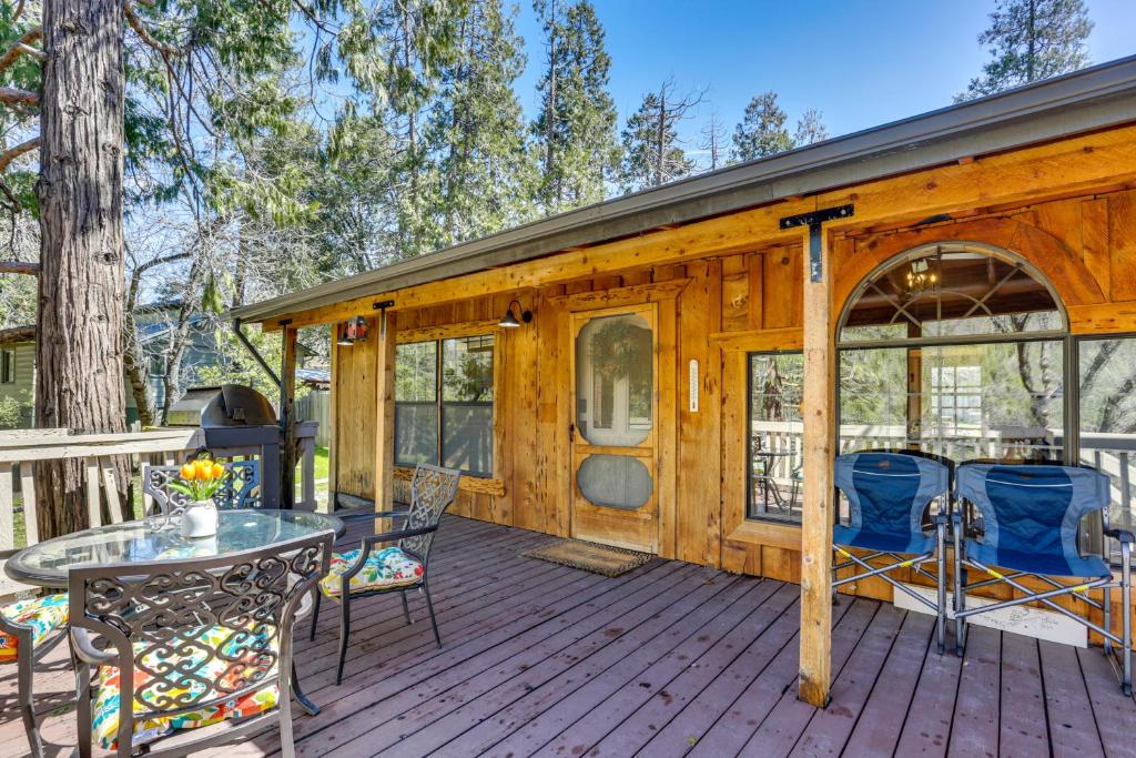 a wooden cabin with a table and chairs on a deck at Idyllic Wishon Vacation Rental about 9 Mi to Bass Lake in Bass Lake Annex