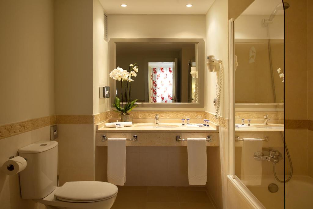 a bathroom with a toilet and a sink and a shower at Ona Marinas de Nerja Spa Resort in Nerja