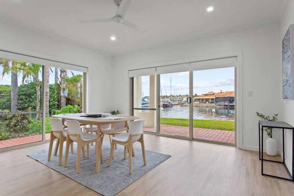 a white dining room with a table and chairs at Waterfront Townhouse - Picturesque Marina Views in Port Lincoln