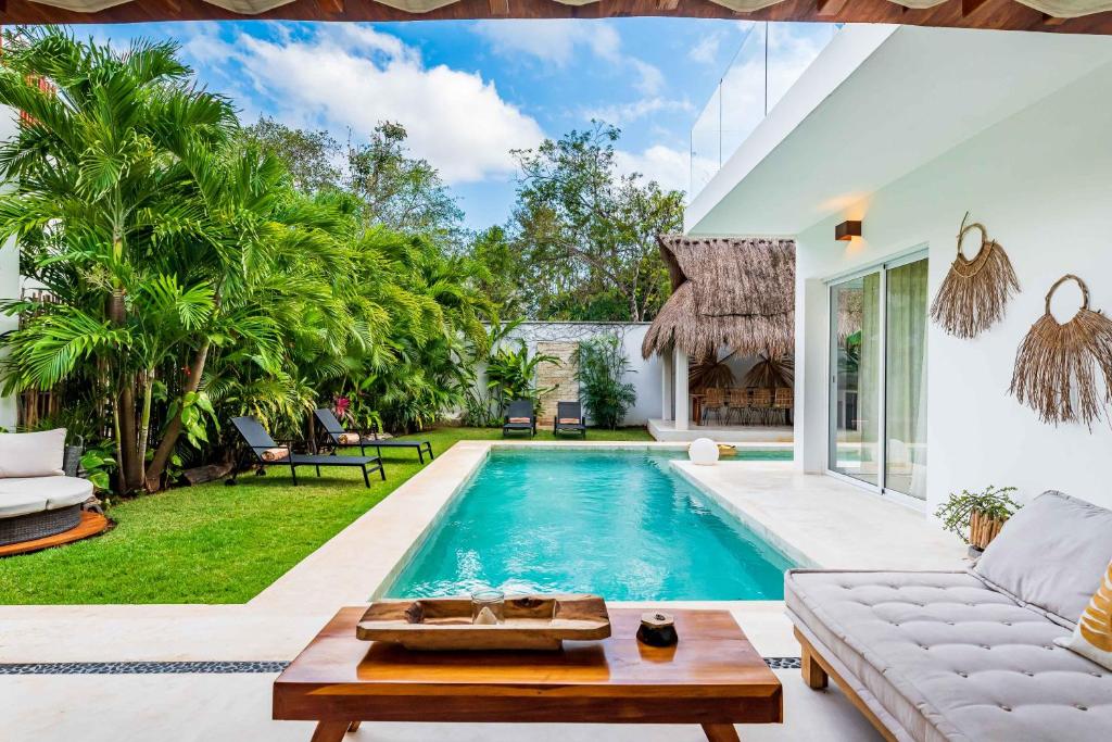 a pool in the backyard of a villa at Villa Ek'Balam & Villa Flamingo, Luxury Villas, Private Pool, Private Garden, Jacuzzi, 24h Security in Tulum