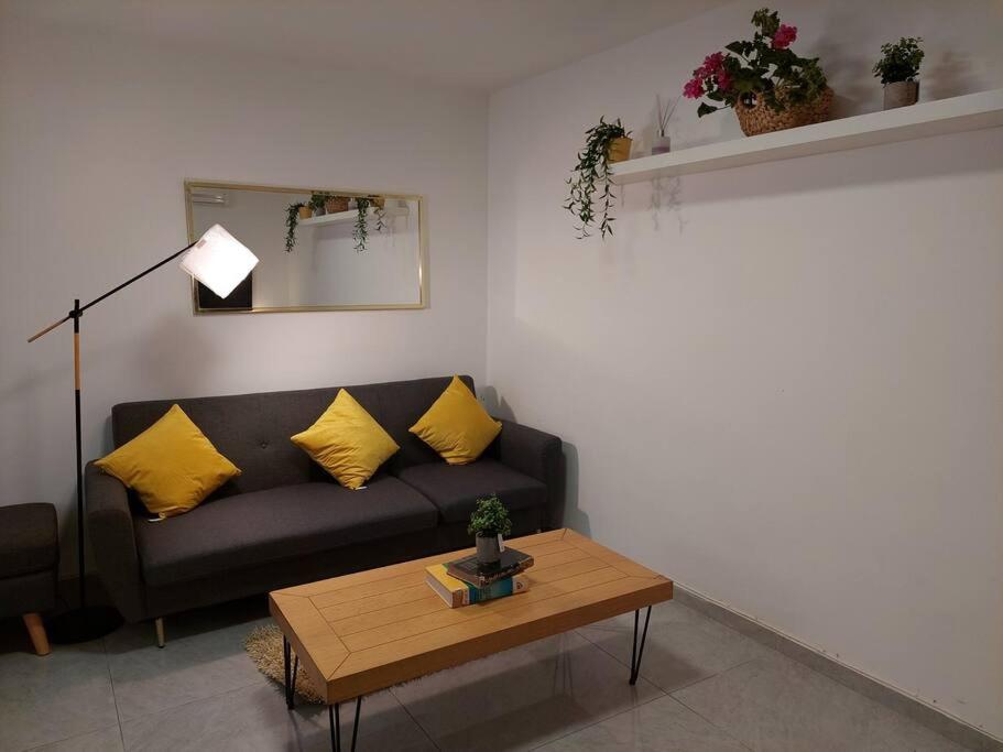 a living room with a couch and a coffee table at Уютная 2-х комнатная квартира недалеко от моря in Ashdod