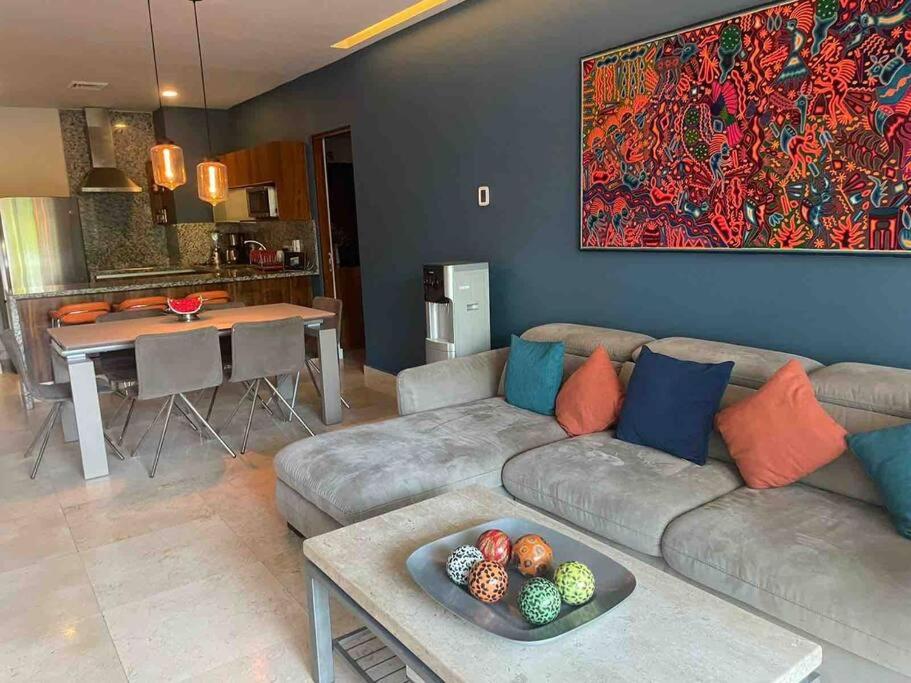 a living room with a couch and a table at Luxury Condo between 5th Avenue and the Beach in Playa del Carmen
