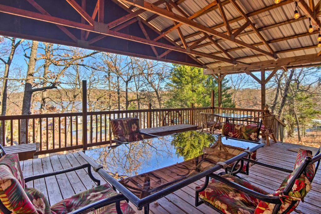 a patio with a table and chairs on a deck at Waterfront House with Boat Slip on Lake Eufaula! in Canadian