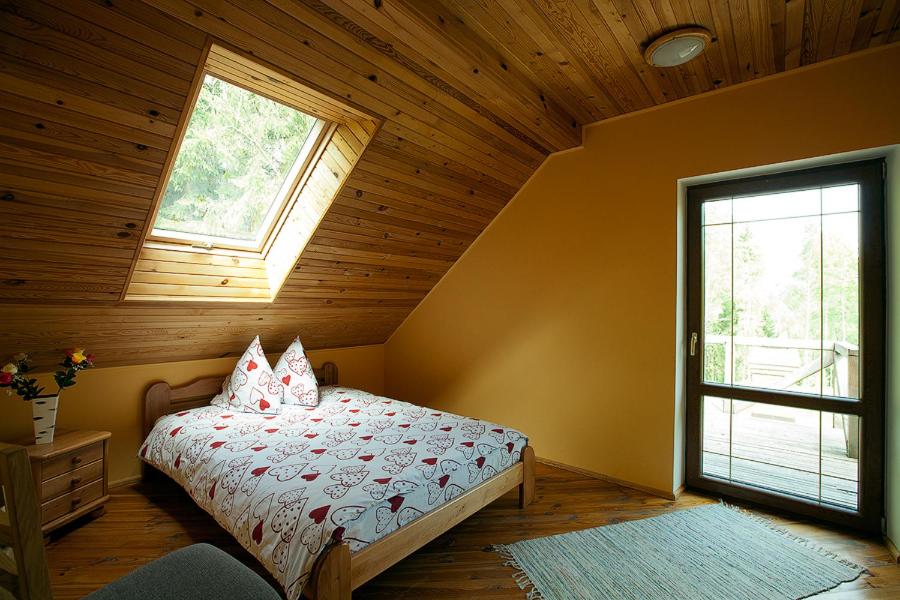 a bedroom with a bed in a room with a window at Kārkli in Kandava