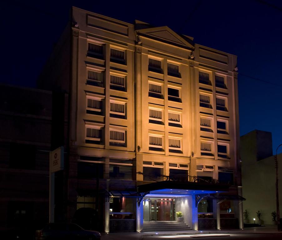 a tall building at night with the lights on at Hotel Patagonia in Río Gallegos