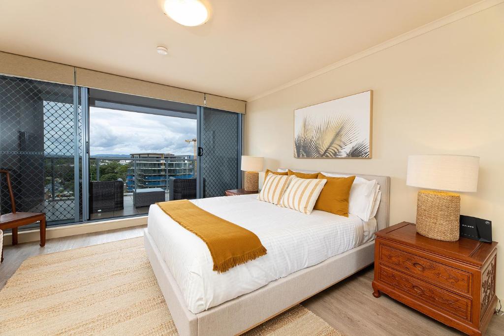 a bedroom with a bed and a large window at The Crest Penthouse 902 in Forster