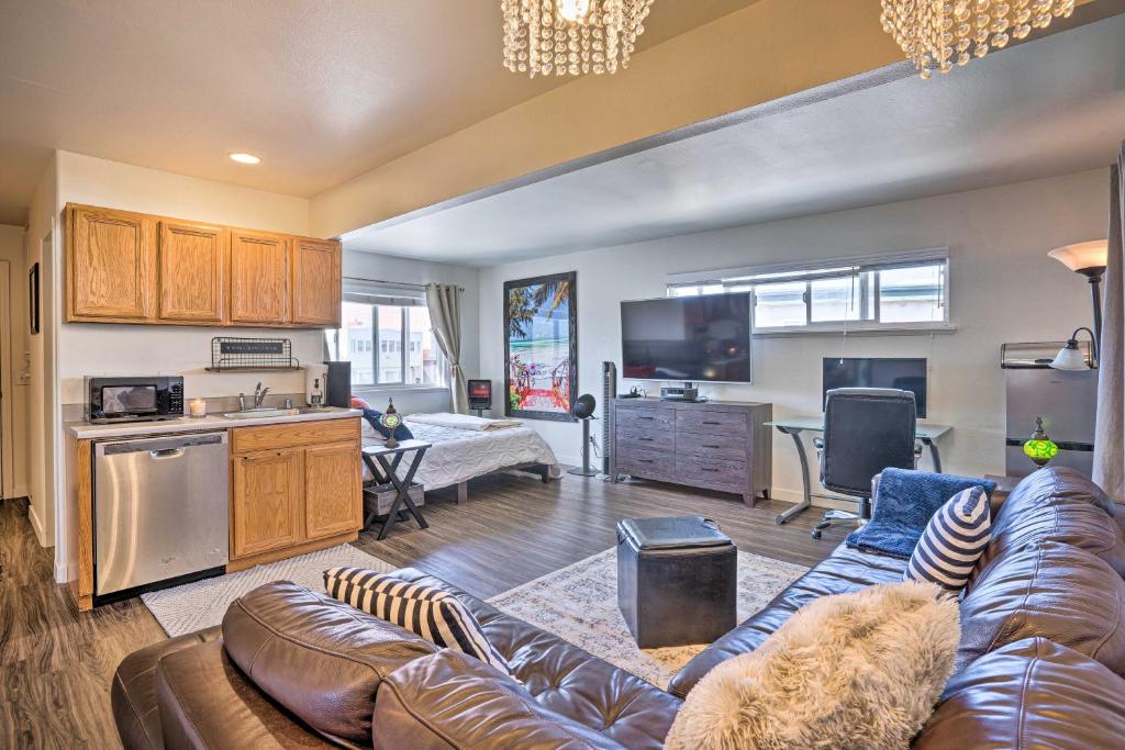a living room with a couch and a kitchen at Newport Beach Vacation Rental - Short Walk to Pier in Newport Beach