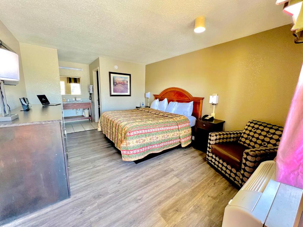 a hotel room with a bed and a couch at Rodeway Inn Expo Center in Spartanburg