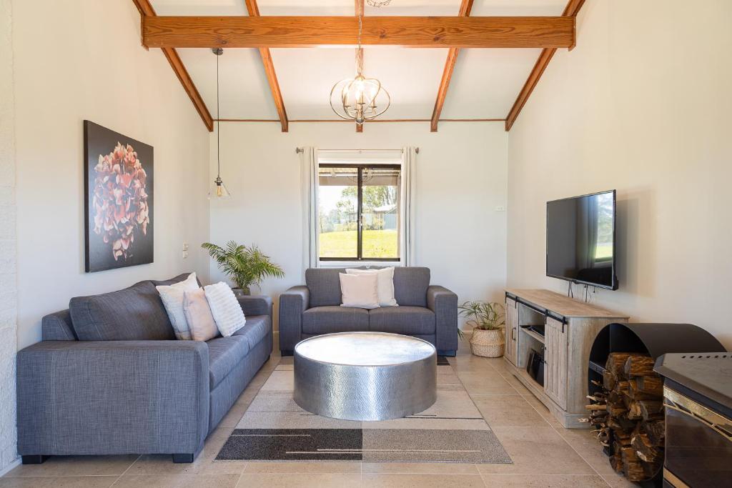 a living room with two couches and a coffee table at Hunter Gleann Pty Ltd in Pokolbin