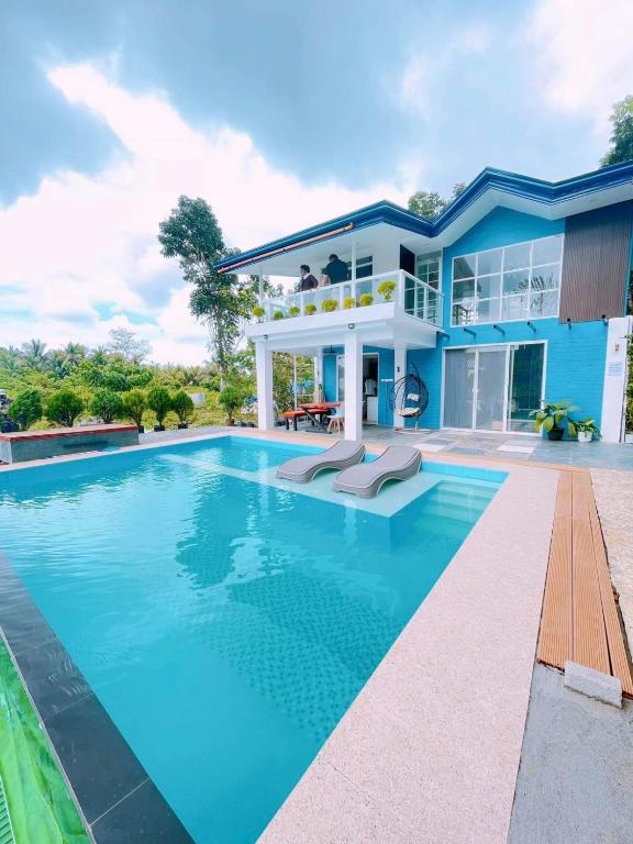 a house with a swimming pool in front of it at The Bleu Mansion Iligan in Iligan City